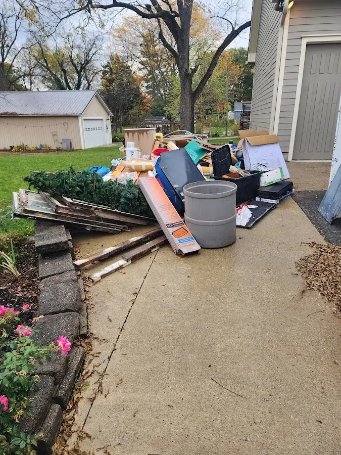 Dumpster being loaded with debris for Roofing Dumpster Rental in Redford